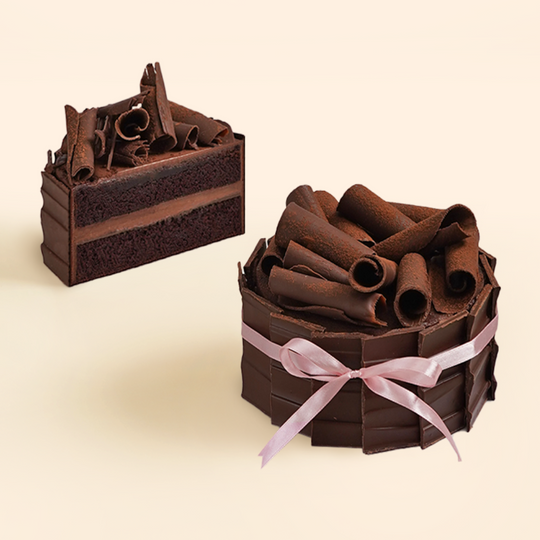 Chocolate birthday cake, extravagant two layer chocolate cake, with chocolate ganache filling and chocolate buttercream, topped with hand made chocolate curls.