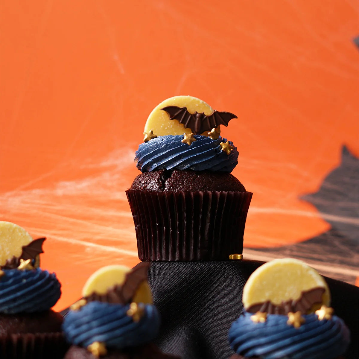 Chocolate Halloween Themed Cupcake with chocolate bat and moon.